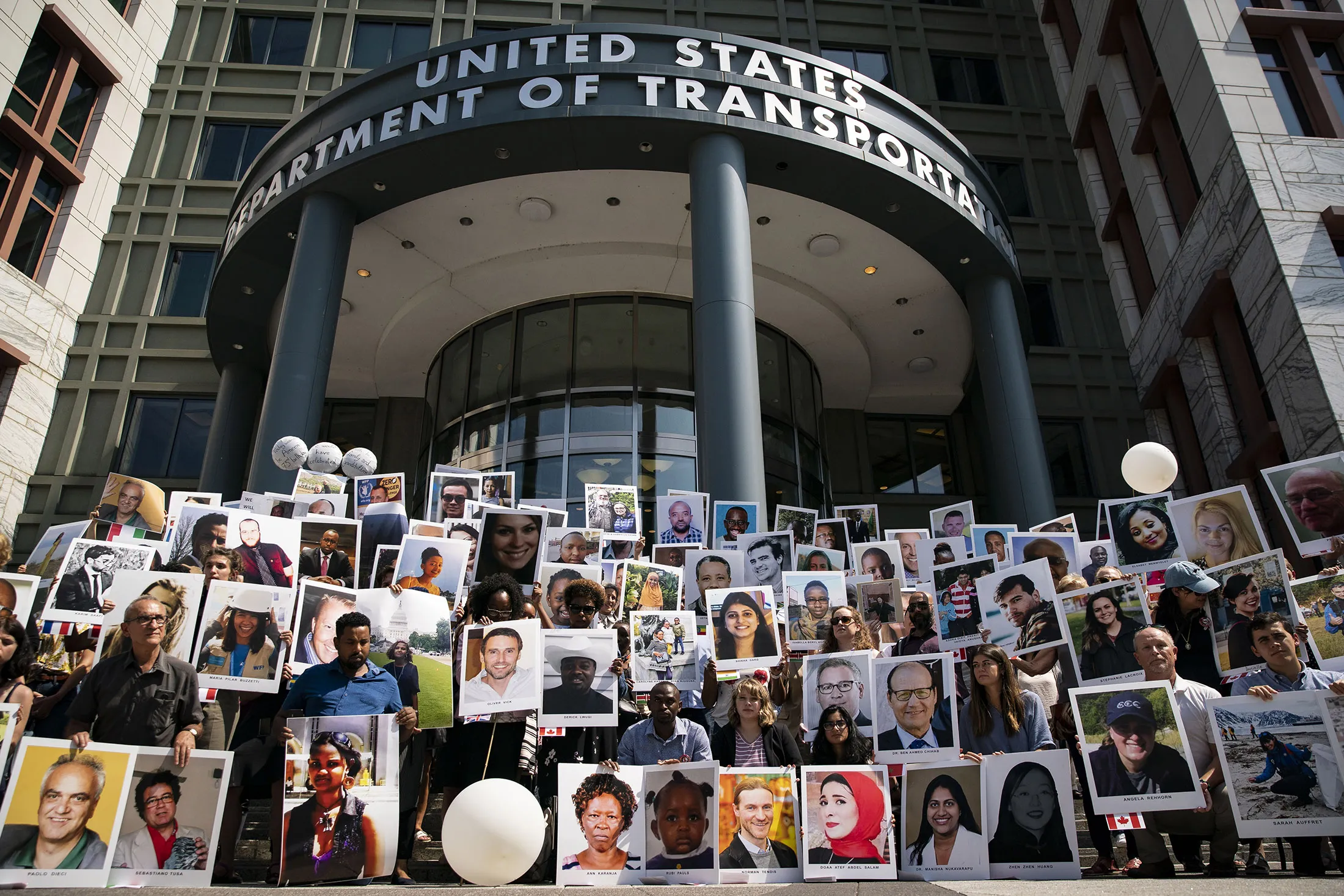 Family members of victims of the Ethiopian Airlines Flight 302 crash hold photos during a vigil outside the US Department of Transportation in Washington in 2019.