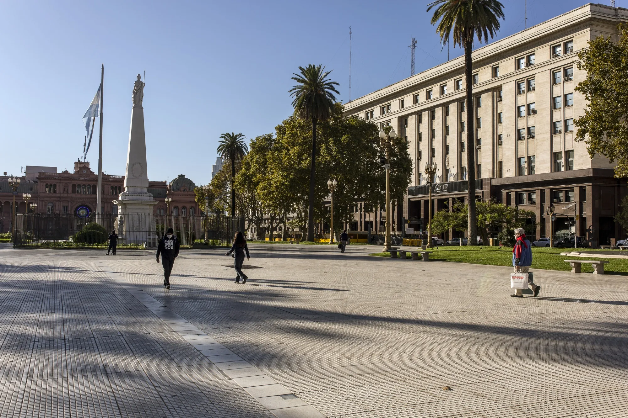 Pedestrians cross Plaza de Mayo in Buenos Aires on April 30.