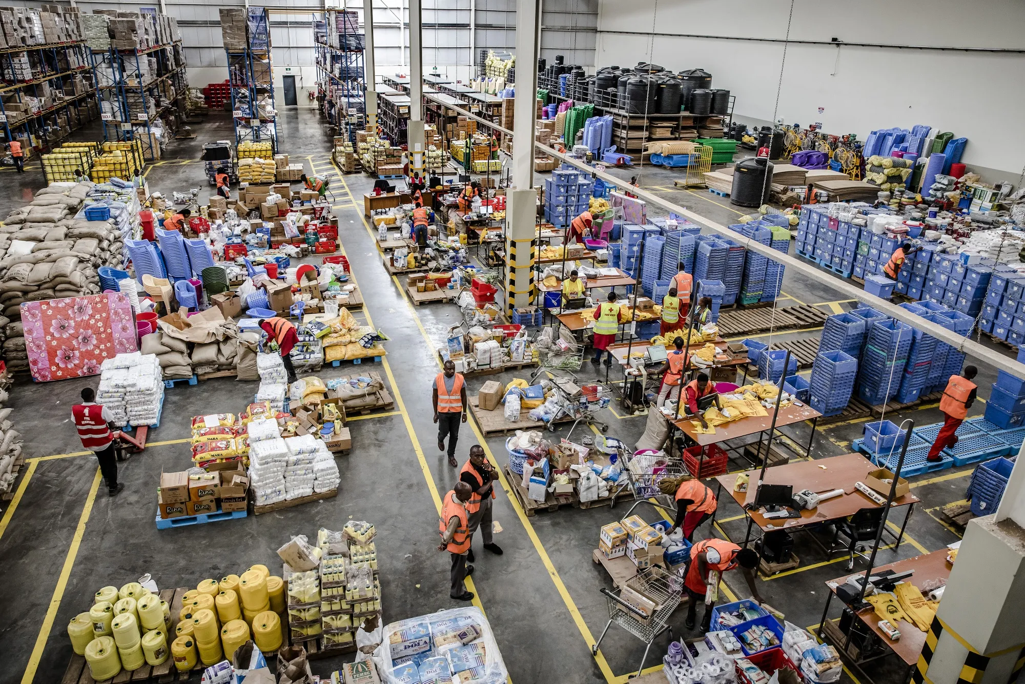 Workers pack orders ready for shipping at a Copia Global logistics and distribution hub at Tatu City Industrial Park, outside Nairobi, Kenya.