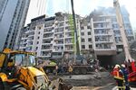Ukrainian rescuers work outside a residential building hit by Russian missiles in Kyiv.