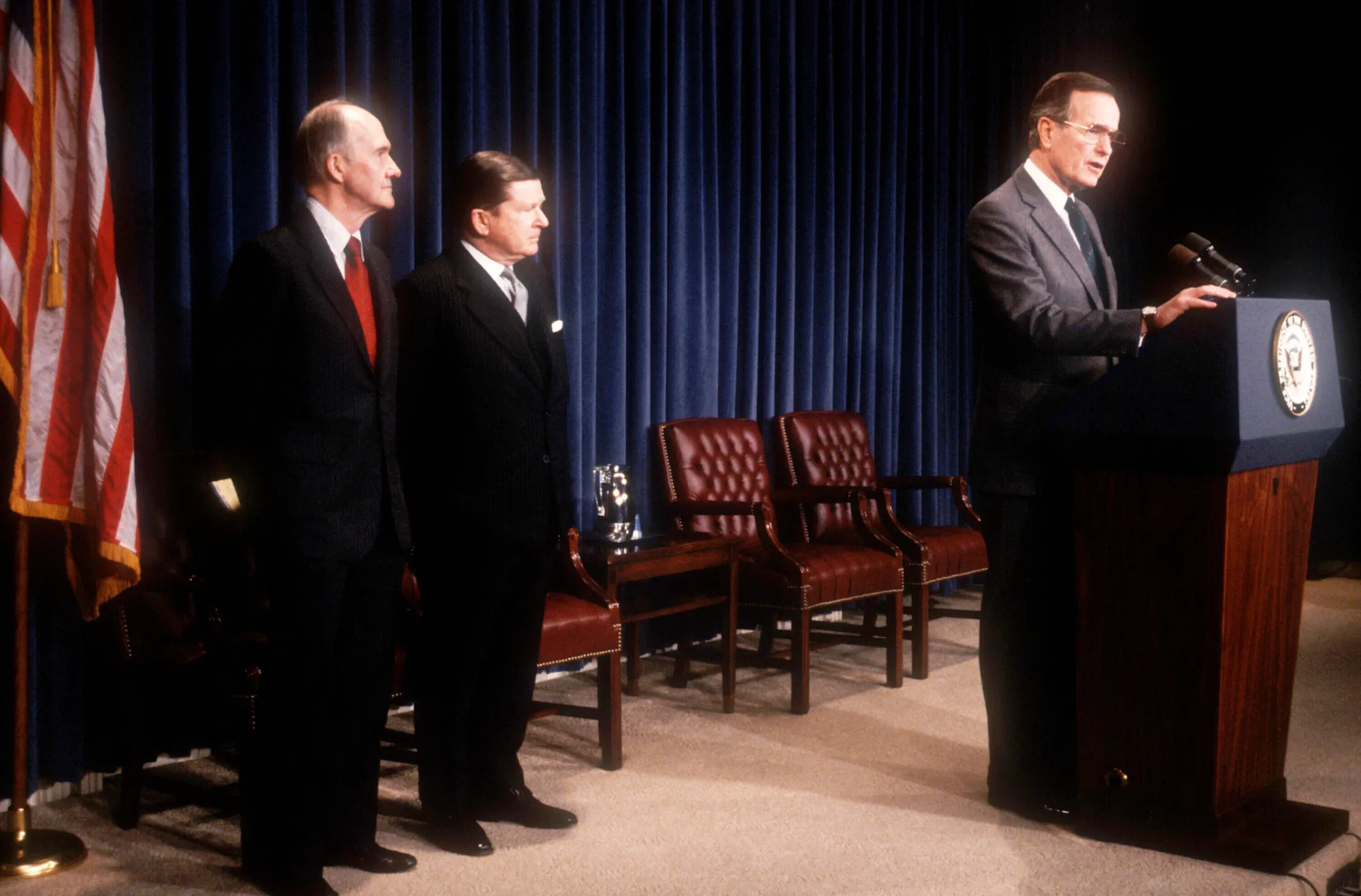 National Security Advisor Brent Scowcroft stands next to John Tower as Vice President George Bush announces the former Senator's nomination for Secretary of Defense Dec. 16, 1988.
