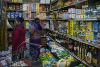 Customers browse goods at a store on the outskirts of New Delhi.