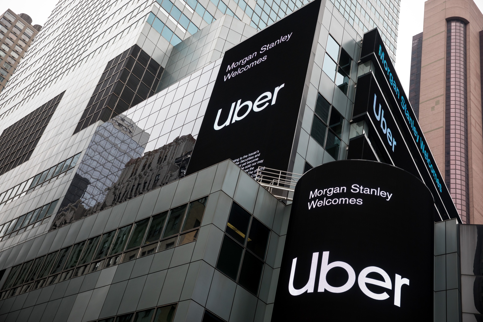 Monitors display Uber signage in front of Morgan Stanley headquarters in the Times Square area of New York.