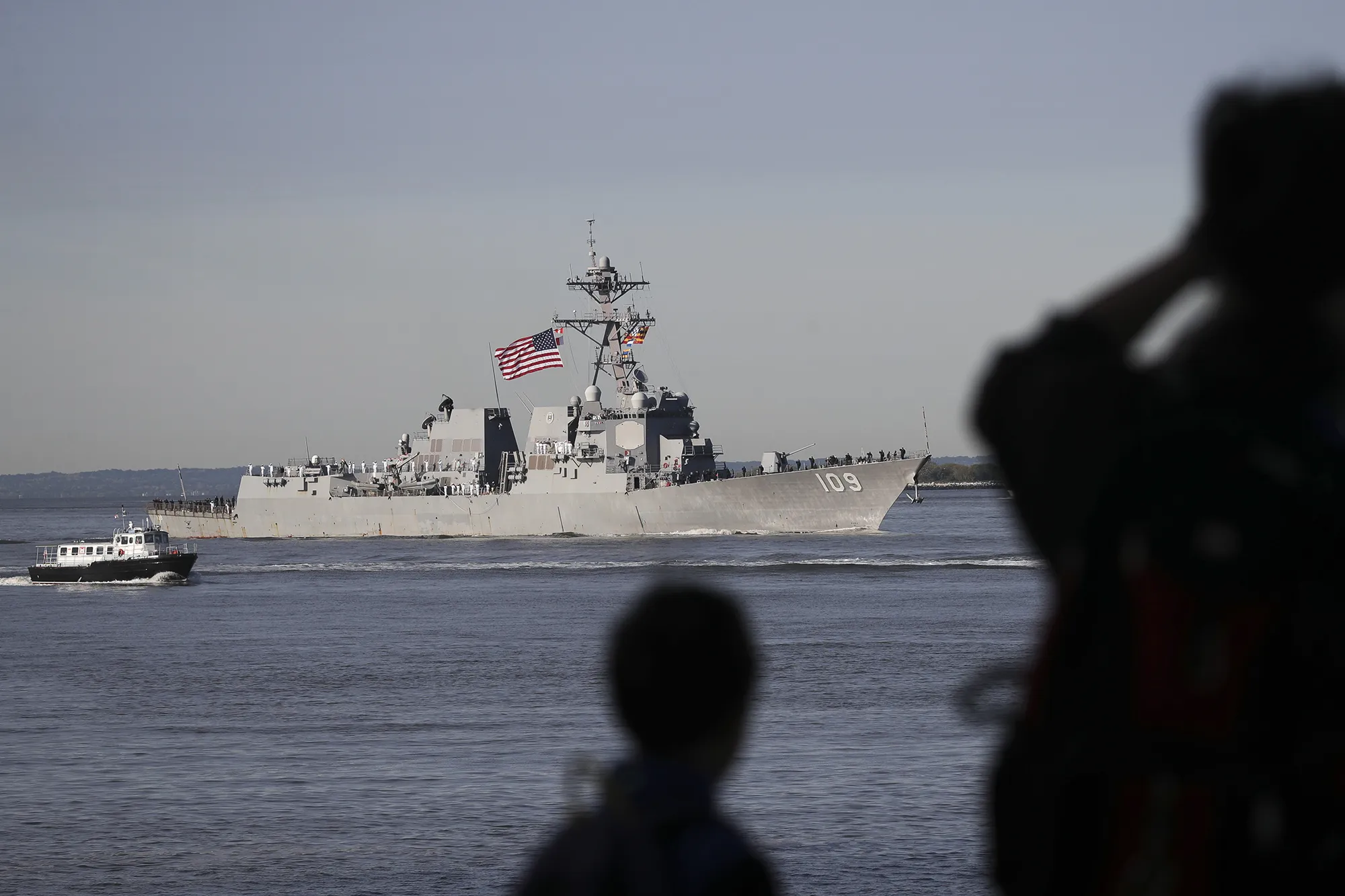 People watch the USS Jason Dunham in 2019.&nbsp;