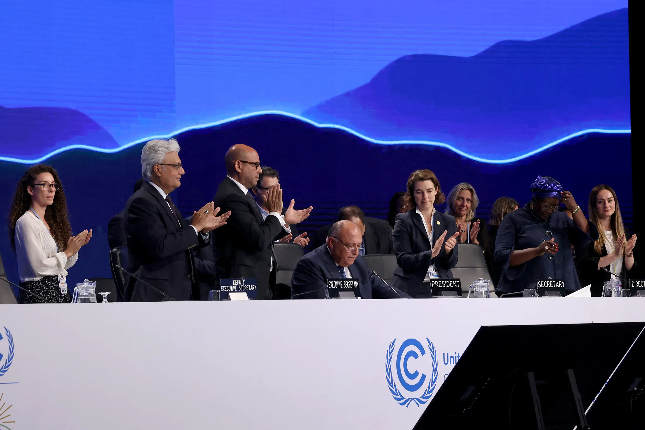 Sameh Shoukry, center, speaks during the closing session of the COP27&nbsp;on Nov.&nbsp;20.