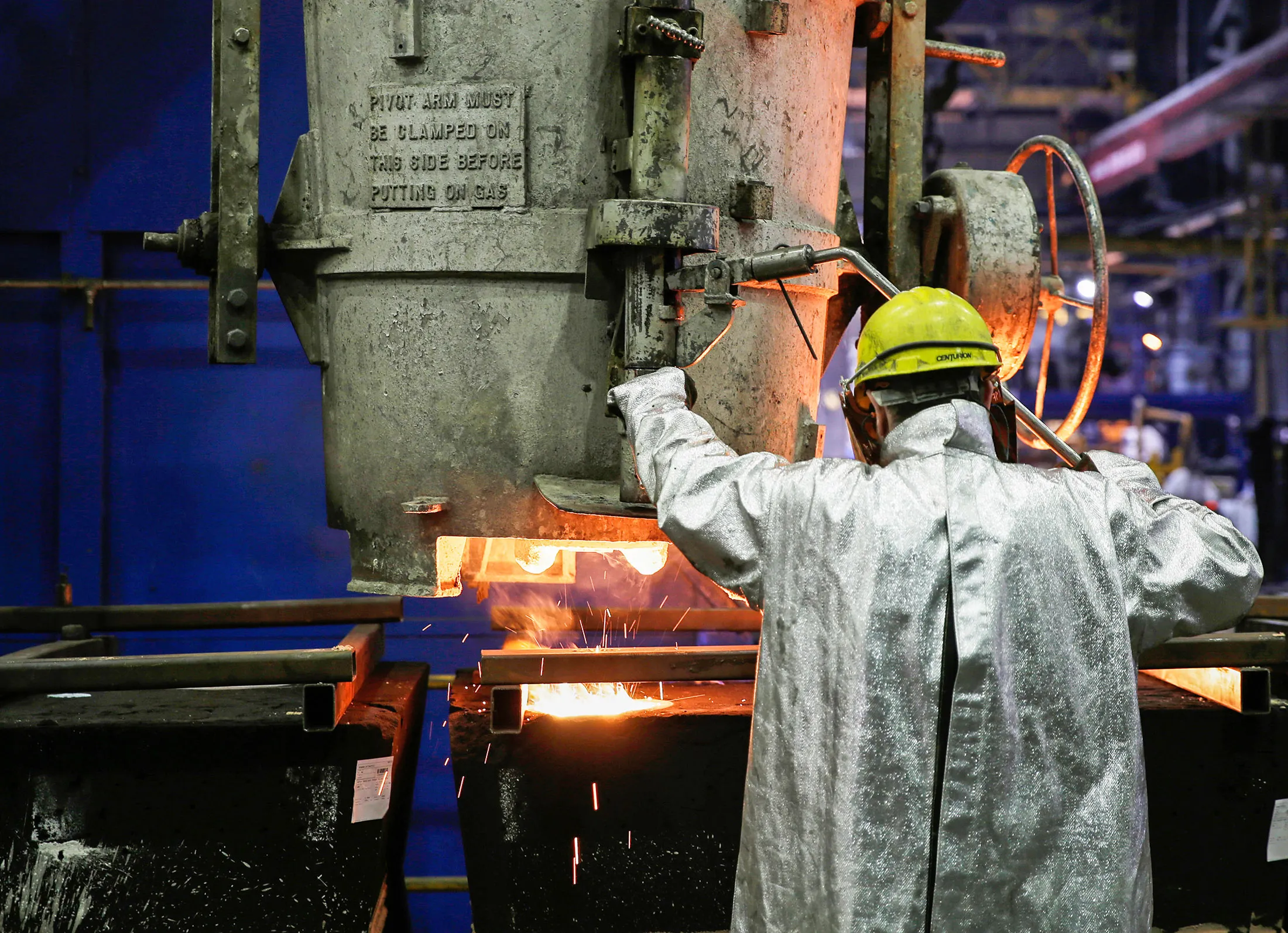 A worker pours molten metal into casts for the manufacturing of parts of centrifugal pumps at Weir Minerals Europe Ltd., a division of Weir Group Plc, in Todmorden, U.K. on Thursday, March 3, 2016. Weir Group Plc manufactures industrial pumps to transport liquids to the mining and oil and gas industries, and Weir's strategy is to establish, then service, its installed base.
