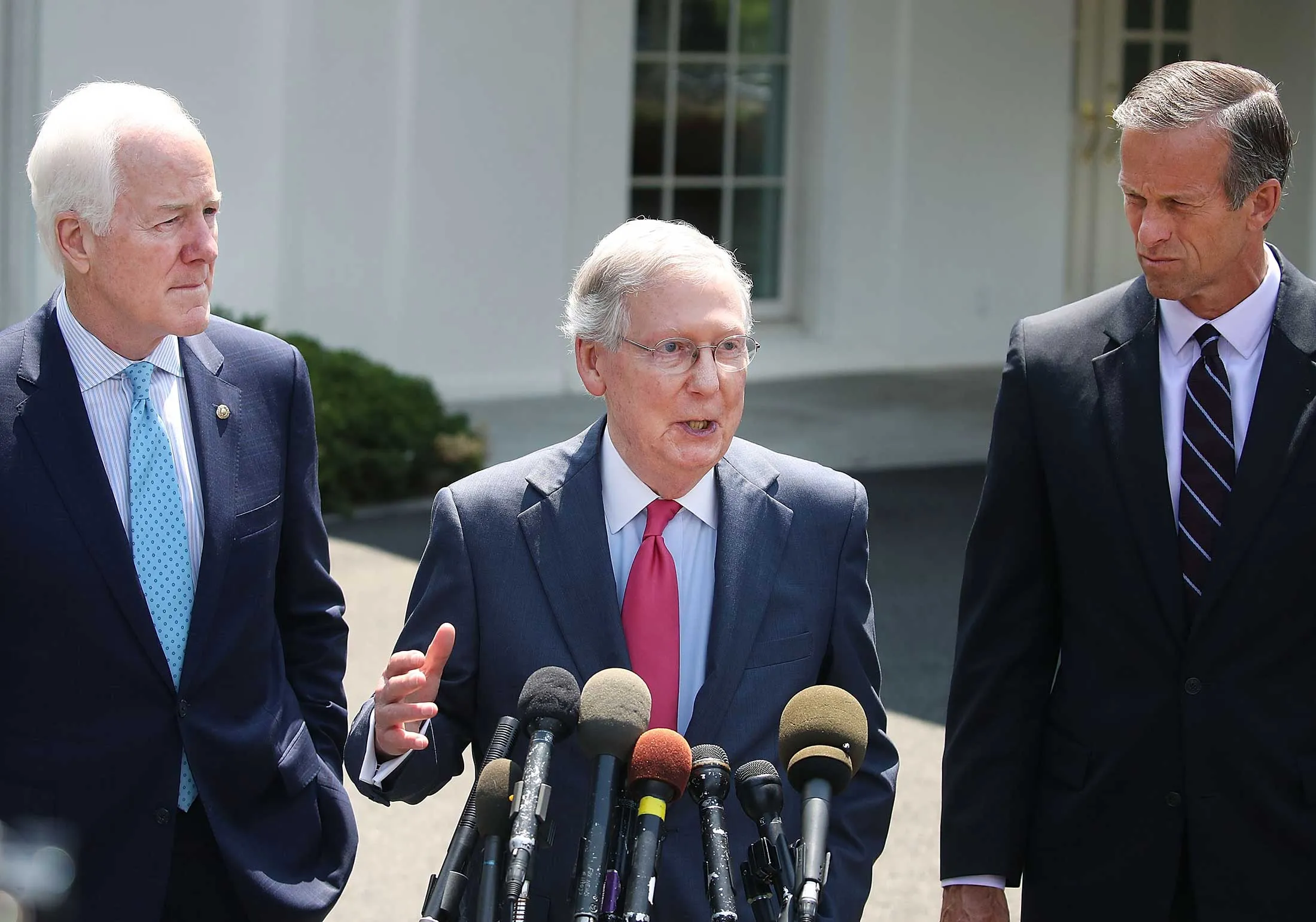 From left, Senator John Cornyn (R-Texas), Senate Majority Leader Mitch McConnell (R-Ky.), and Senator John Thune (R-S.D.) speak to the media at the White House on July 19. The senators met with President Trump to discuss the health-care bill.
