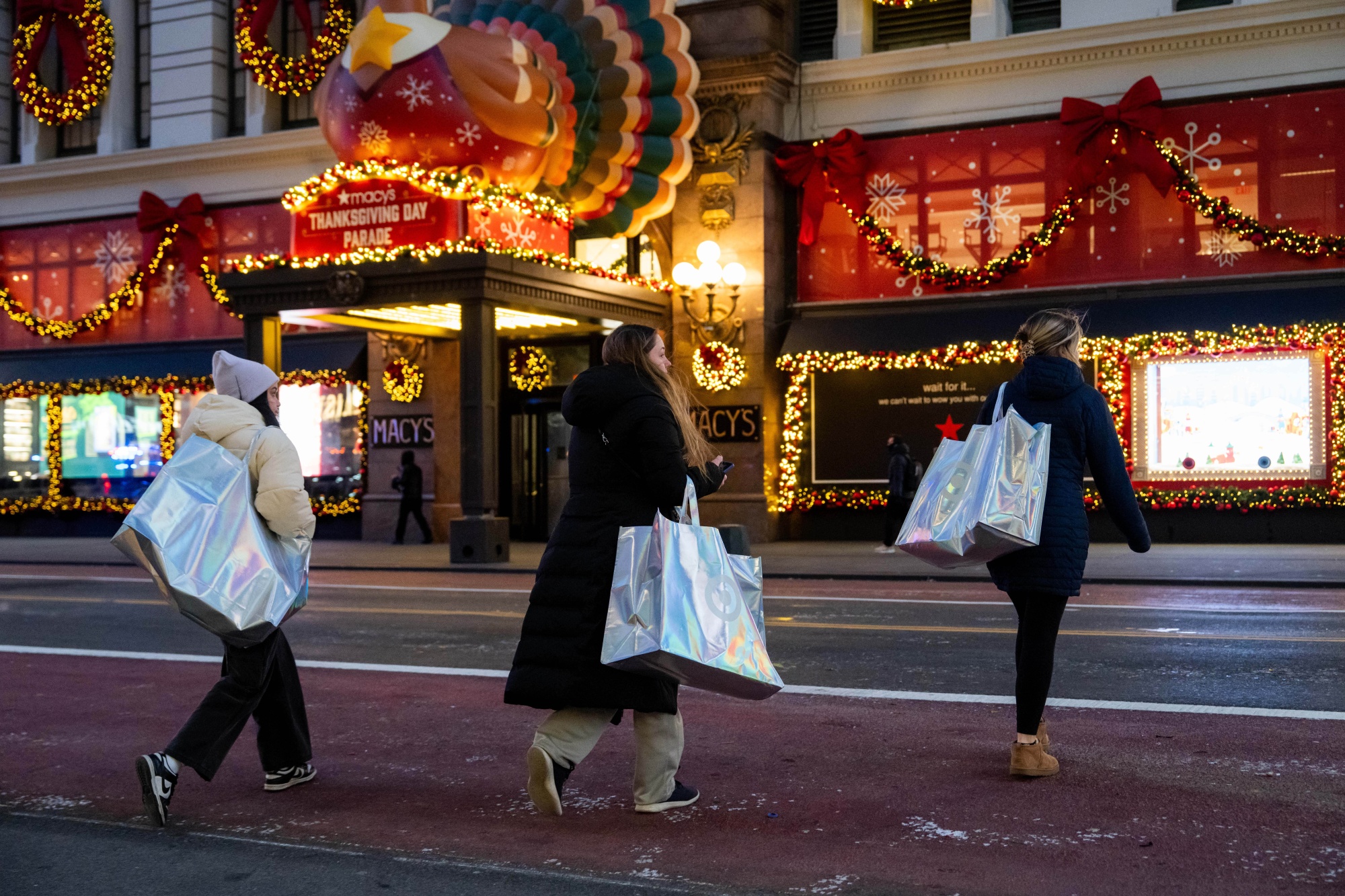 Shoppers carry shopping bags outside the Macy's store on Black Friday in New York on Nov. 28.