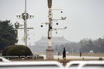A member of the People's Armed Police stands guard under surveillance cameras on the outer perimeter of Tienanmen Square in Beijing, China.