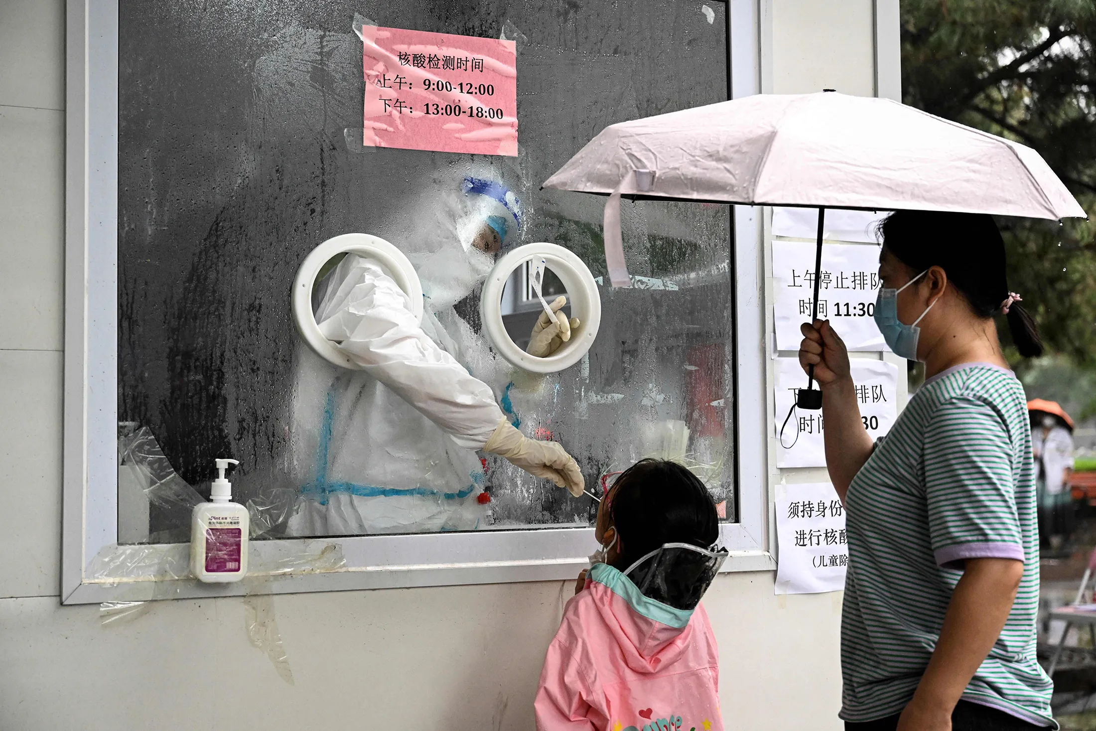 A health worker takes a swab sample from a child in Beijing on June 22.