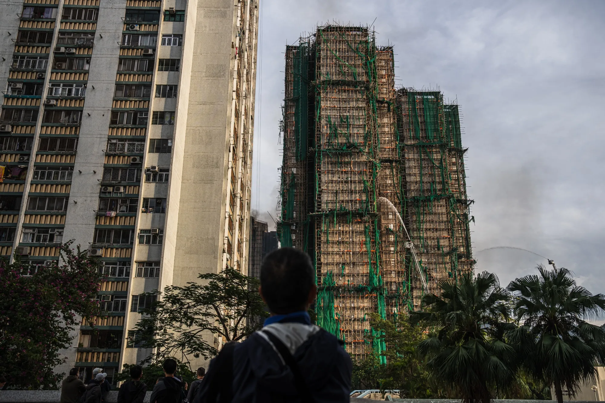 Firefighters hose down a building at the Wang Fuk Court residential estate in Hong Kong, on&nbsp;Nov. 27.