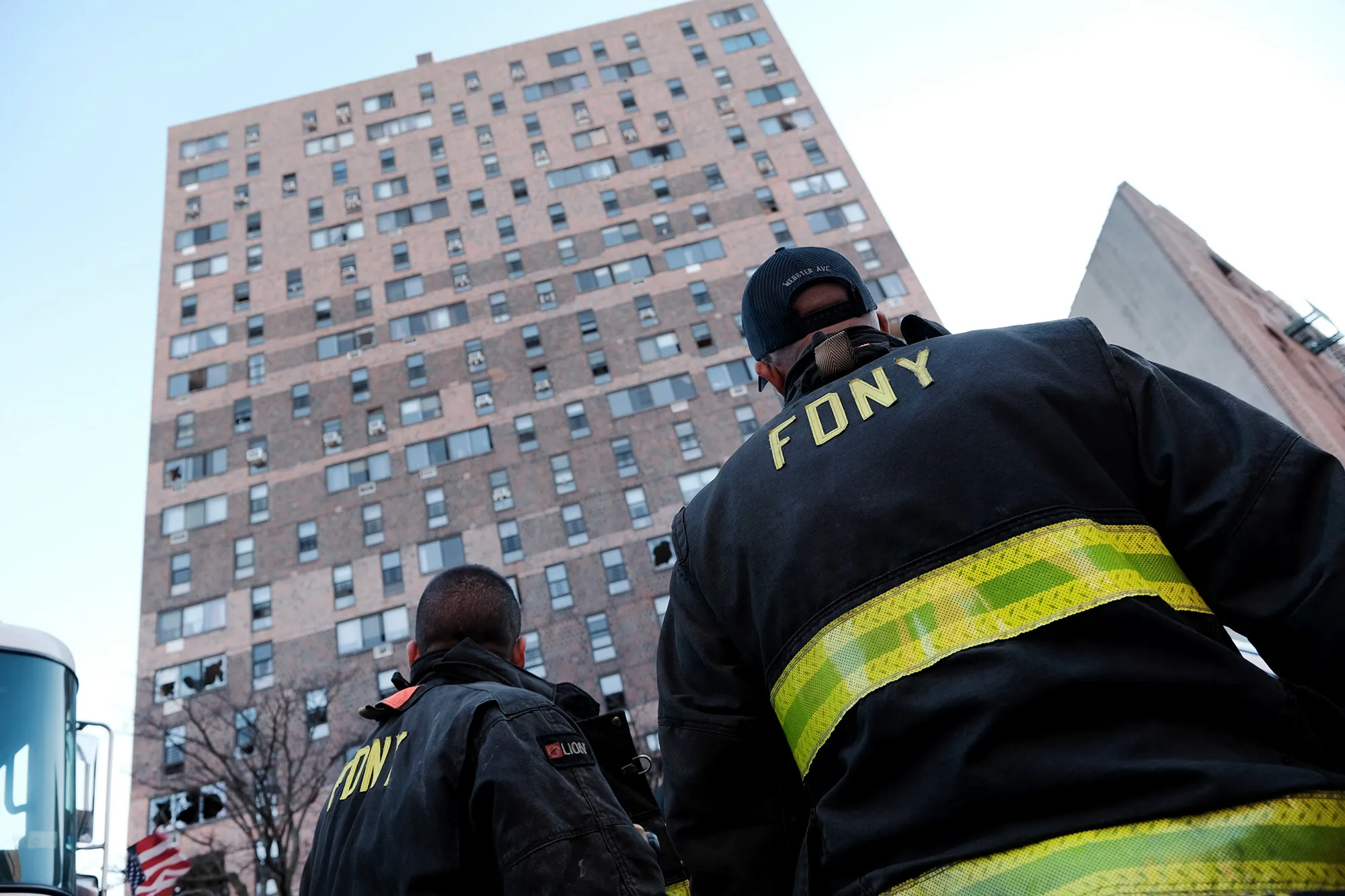 Firefighters in front of 333 E. 181st Street&nbsp;a day after a fire swept through the complex, on Jan. 10.