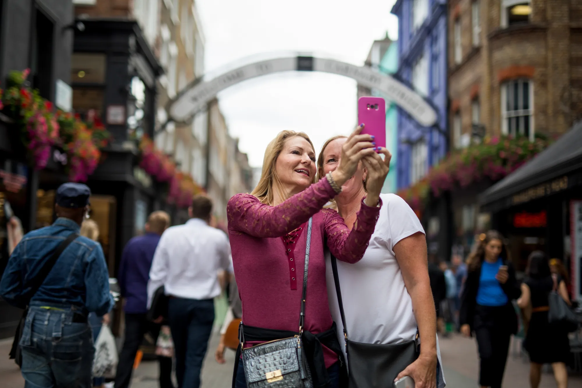 Tourists take a selfie on Carnaby Street in London.