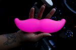 Maya Jackson, a Lyft driver from Sacramento, holds a Lyft Glowstache.