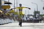 Belgium's Wout Van Aert, wearing the overall leader's yellow jersey celebrates as he crosses the finish line to win the fourth stage of the Tour de France cycling race over 171.5 kilometers (106.6 miles) with start in Dunkerque and finish in Calais, France, Tuesday, July 5, 2022. (AP Photo/Daniel Cole)
