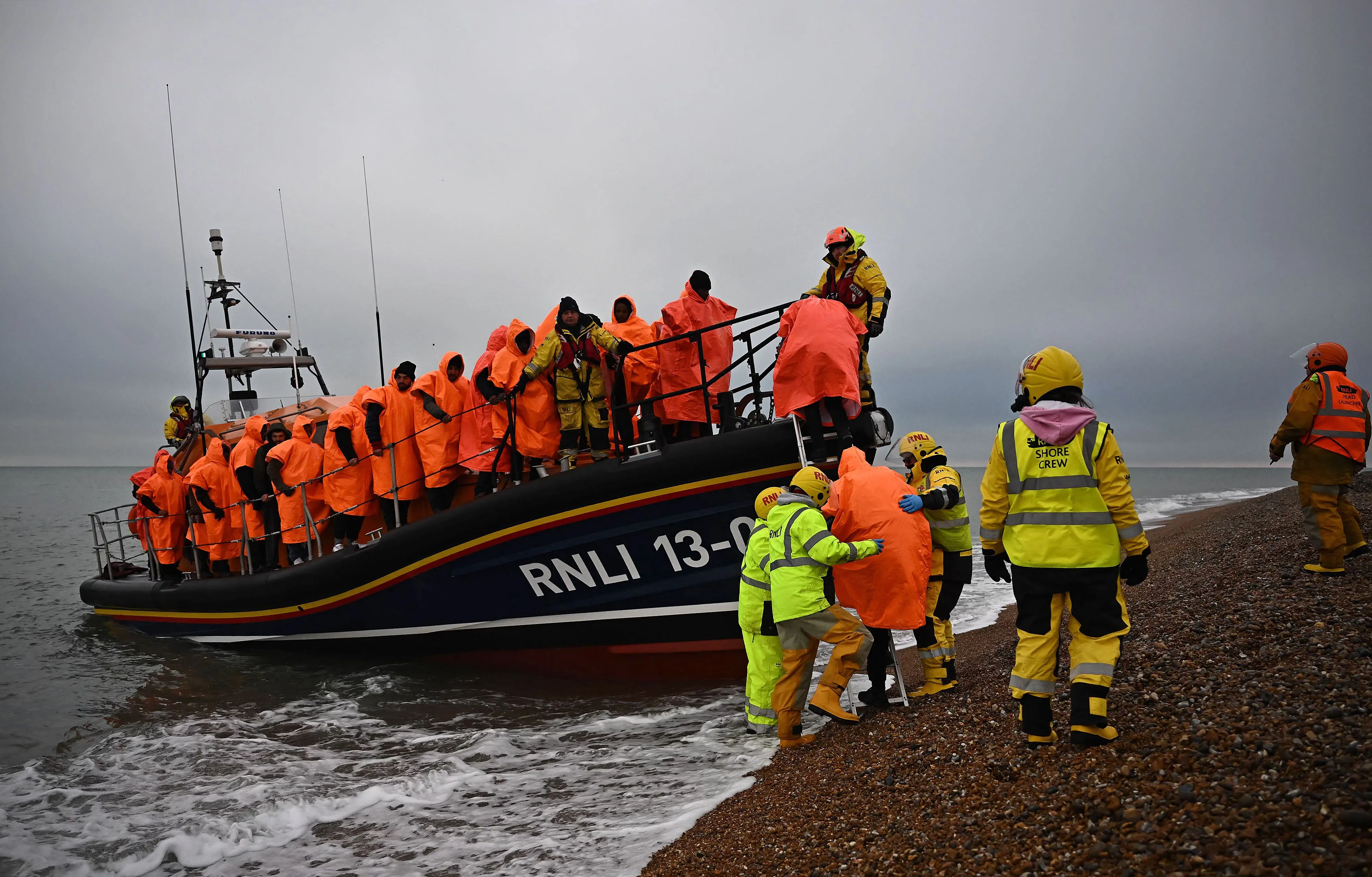 Migrants are helped ashore&nbsp;at Dungeness, England after attempting to cross the English Channel.&nbsp;