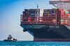 A tugboat guides the Mediterranean Shipping Co. (MSC) Mia container ship arriving at the Port of Los Angeles in Los Angeles, California, U.S., on Wednesday, April 1, 2020. The ship is the largest vessel of its type to ever call in the U.S. and is capable of carrying 23,756 containers.