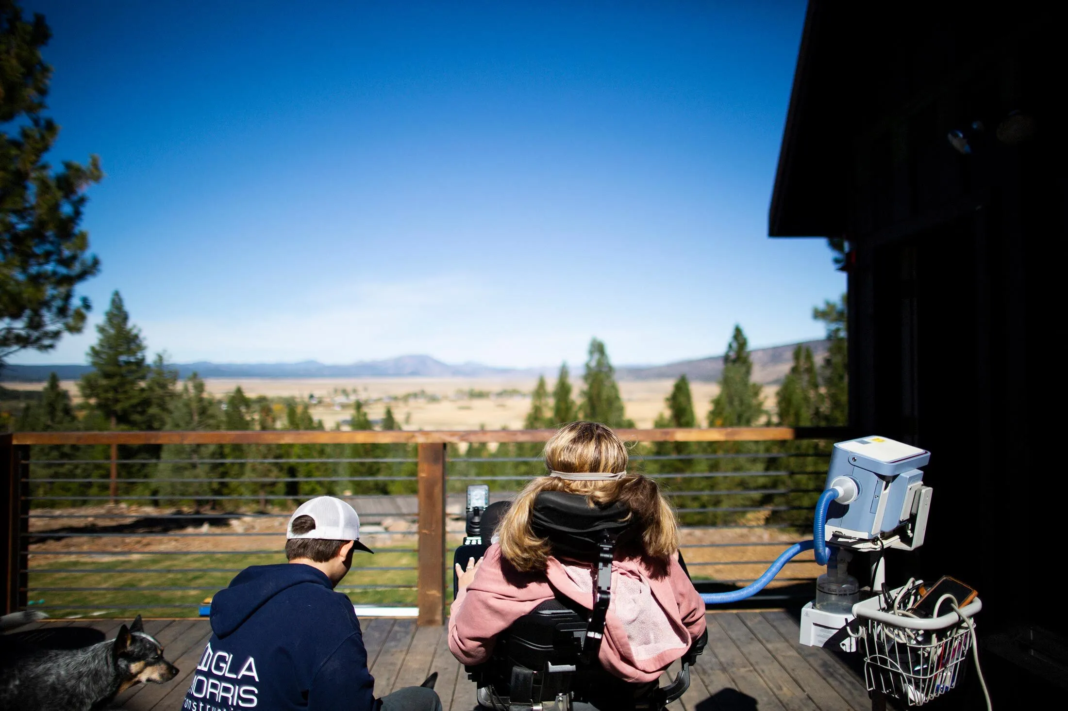 Morris at home on her porch, where she intends to die, with her 20-year-old son, Justin, and their dog, Honey.