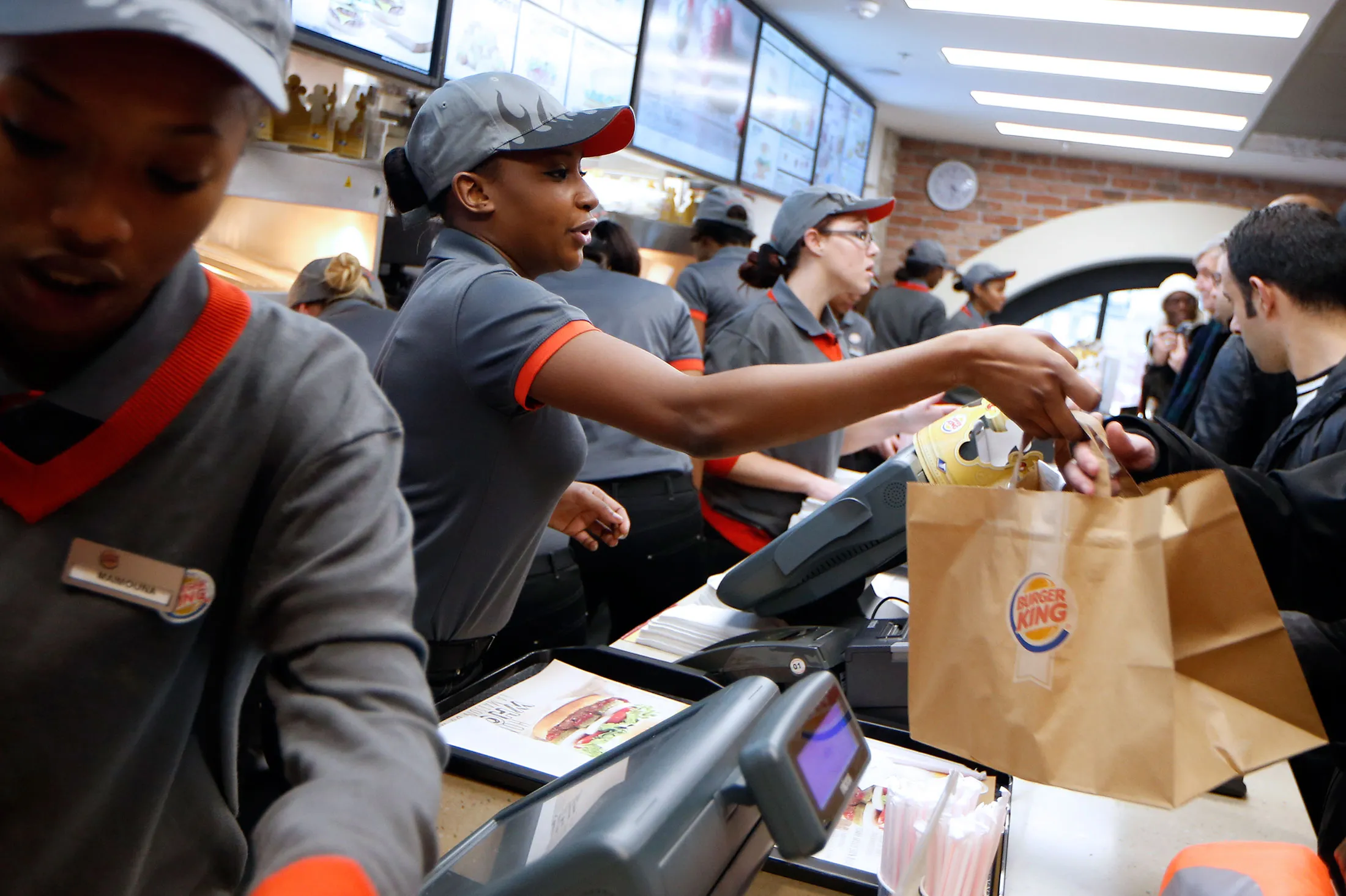 Clients order their meal at a Burger King store in Saint-Lazare railway station in Paris.
