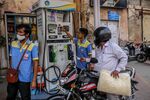A motorcyclist waits to fill up at a gas station in Hyderabad, India.