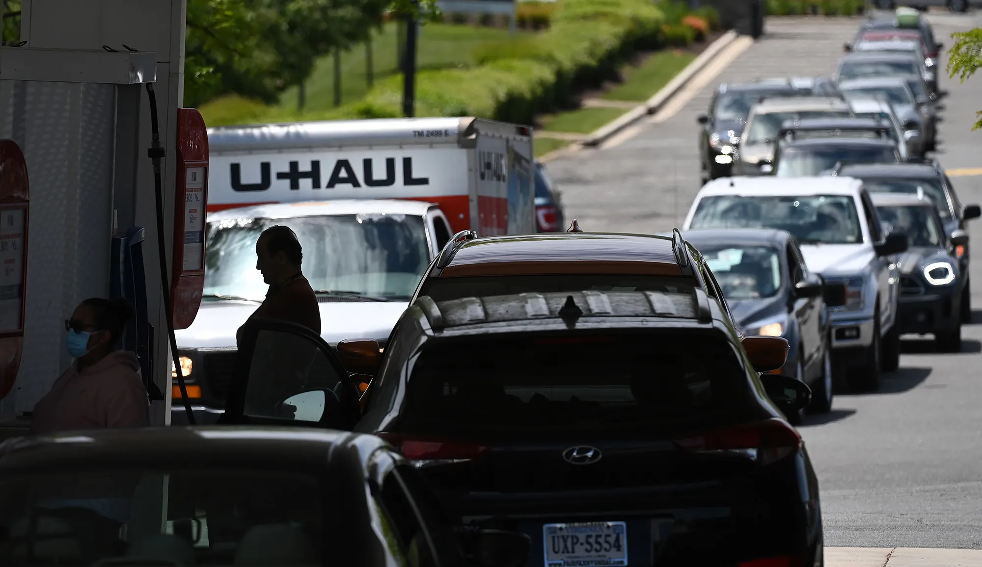 People wait in long lines at a gas station in Springfield, Virginia.