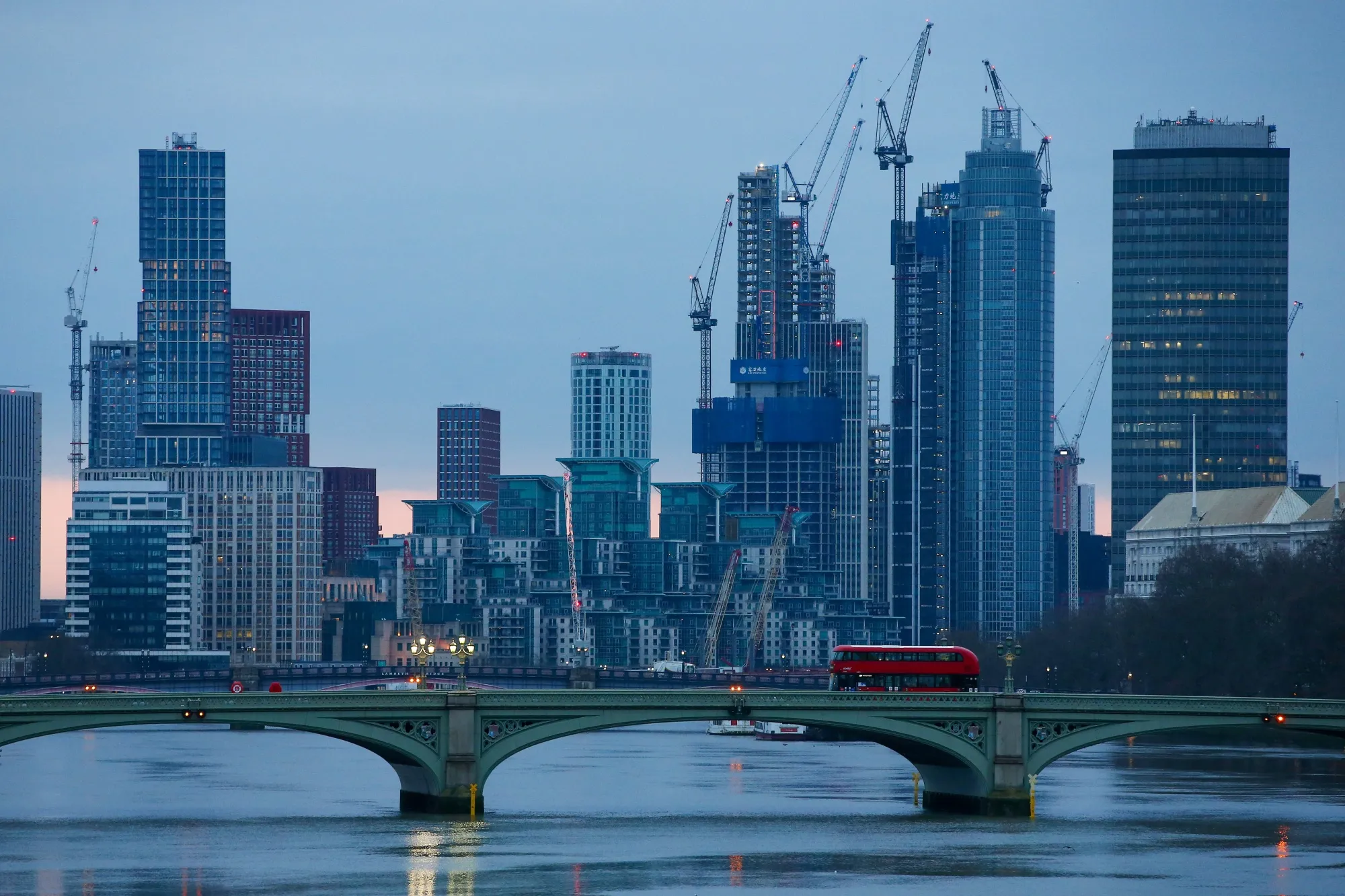 A London bus crosses Westminster Bridge over the River Thames&nbsp;in London, U.K.