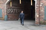 Paterson walks through the remains of the city's factories en route to work.