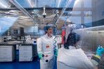 Chinese virologist Shi Zhengli (L) is Shi Zhengli inside the P4 laboratory in Wuhan.