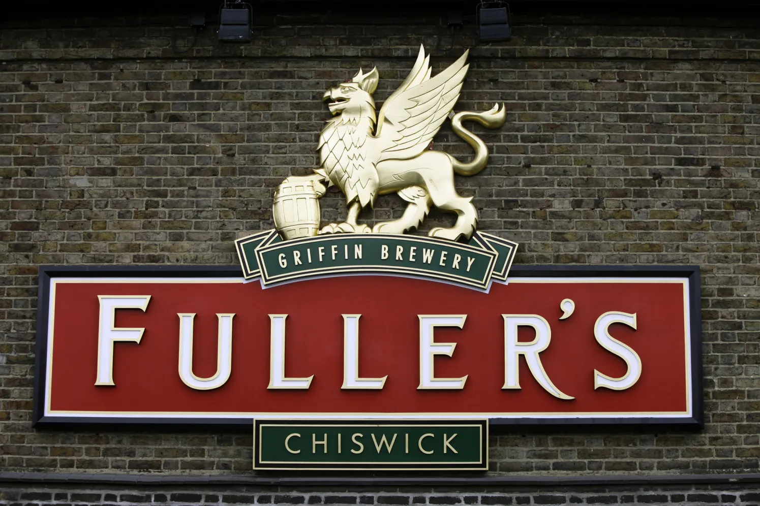 A sign hangs on a wall outside the Fuller Smith & Turner Plc brewery in London.