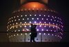 A woman carrying a boy walks past the Oriental Pearl Radio & TV Tower in the Lujiazui district of Shanghai, China, on Friday, April 24, 2015. Yuan forwards headed for their best month since 2012 on bets China will use stimulus measures rather than a weaker exchange rate to spur economic growth as it bolsters the case for the yuan being named a global reserve currency.
