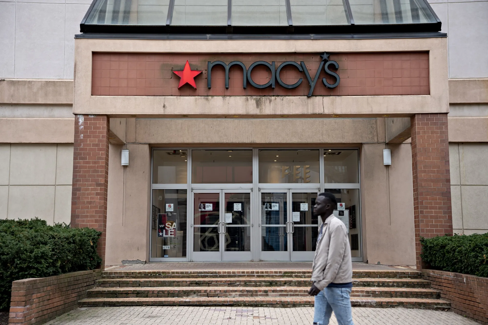 A pedestrian walks near a closed Macy's Inc. store in Arlington, Virginia, U.S., on&nbsp;March 31.