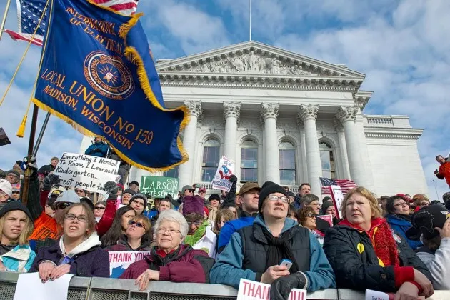 A crowd addressing wage issues at the State Capitol building in Madison, Wisc., in 2011