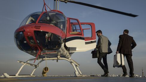 A passenger prepares to board an UberCopter.
