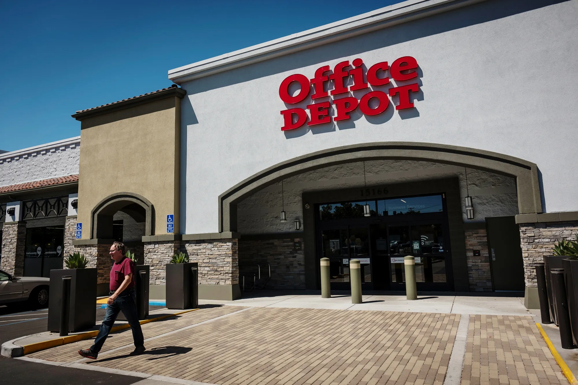 A customer exits an Office Depot Inc. store in Los Gatos, California.