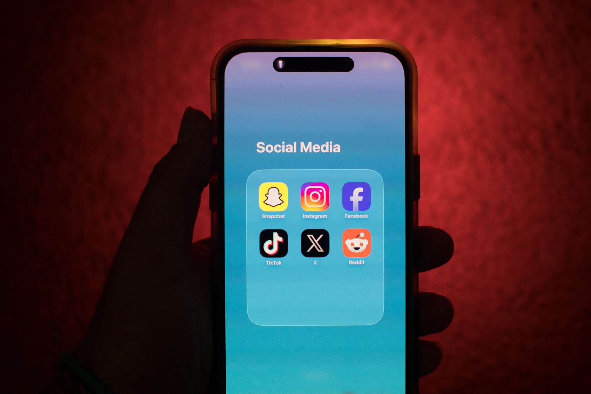 Social media app icons for Snapchat, Instagram, Facebook, TikTok, X and Reddit are displayed on a smartphone in an arranged photograph in Sydney, Australia, on Wednesday Feb. 11, 2026. Major social media platforms blocked 4.7 million underage accounts in Australia in December as the country's landmark social media ban for under-16s took effect. Photographer: Brent Lewin/Bloomberg
