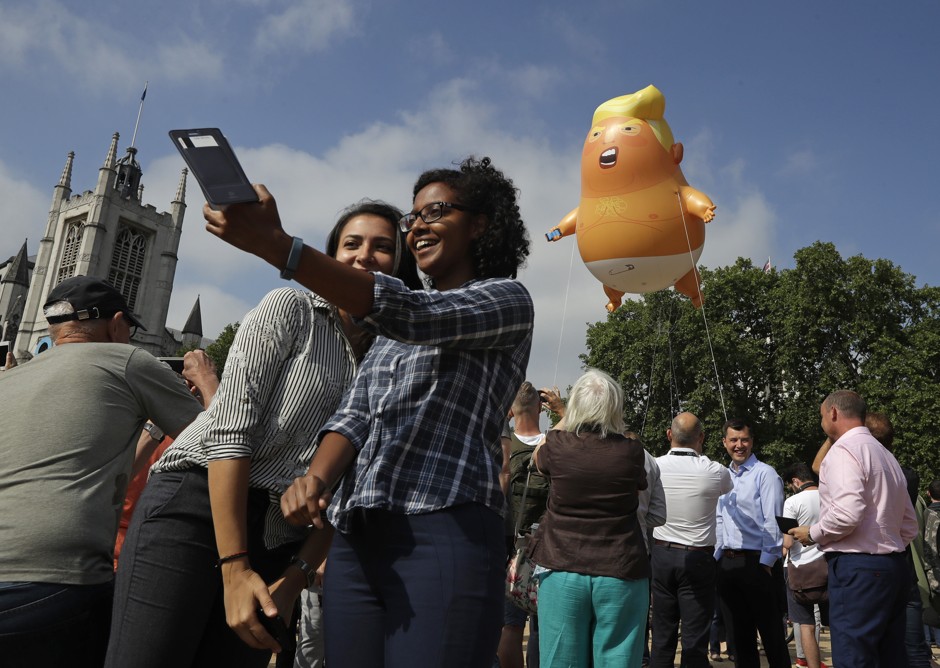 Protesters (maybe?) take a snap during President Donald Trump's visit to London.