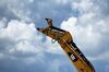 A logo is displayed on an excavator boom at the Caterpillar Inc. manufacturing facility in Victoria, Texas, U.S., on Tuesday, Aug. 7, 2018. Caterpillar Inc. is raising its 2018 profit per share outlook primarily due to the continued strength in many end markets. Recently imposed tariffs are expected to impact material costs in the second half of the year by approximately $100 million to $200 million, the company intends to largely offset these impacts through announced mid-year price increases.