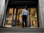 A person enters the Deutsche Bank AG headquarters at 60 Wall Street in New York, U.S.