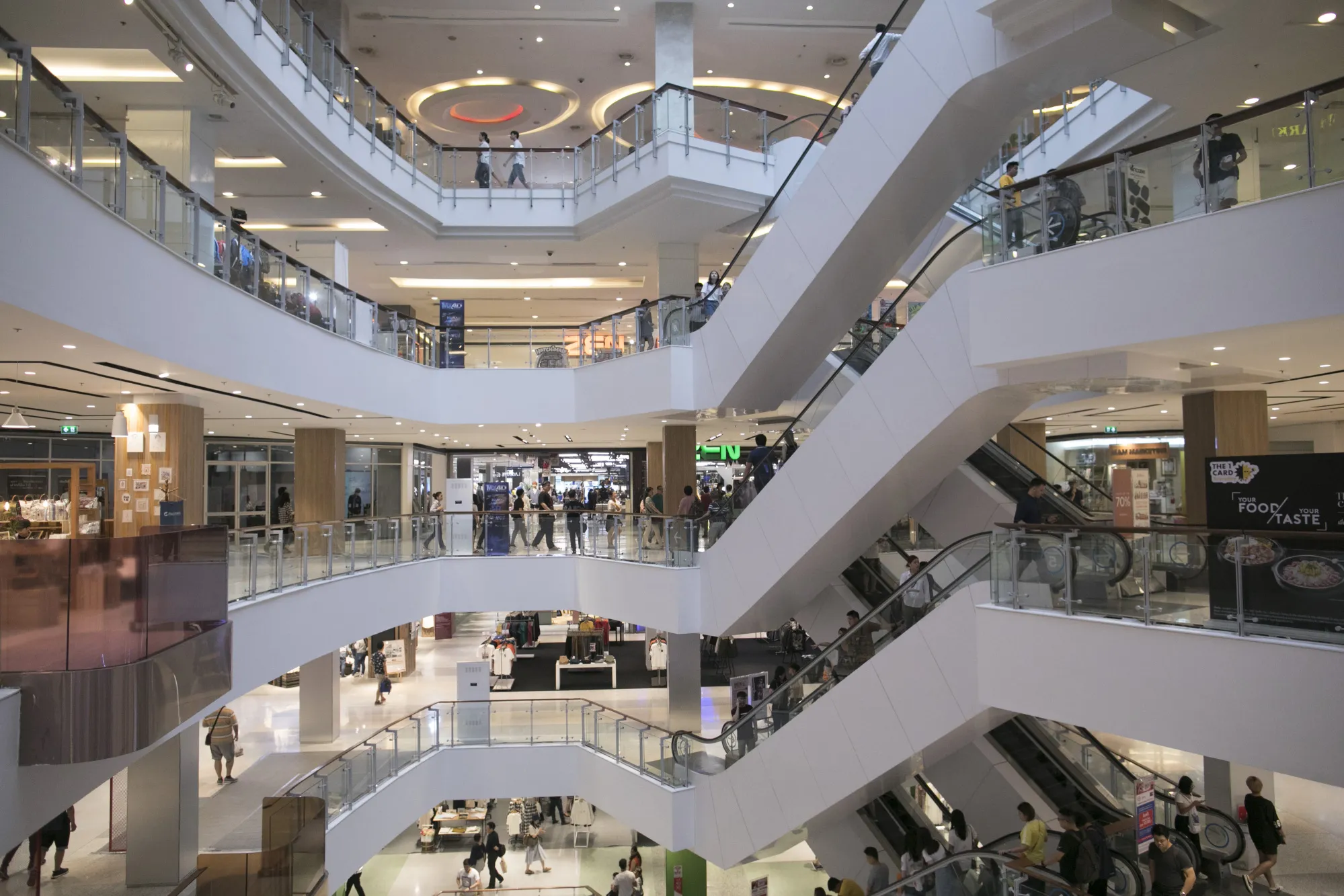 Shoppers ride escalators at the CentralWorld shopping mall in Bangkok, Thailand.
