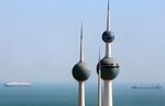 Ships sail beyond the Kuwait water towers in Kuwait.