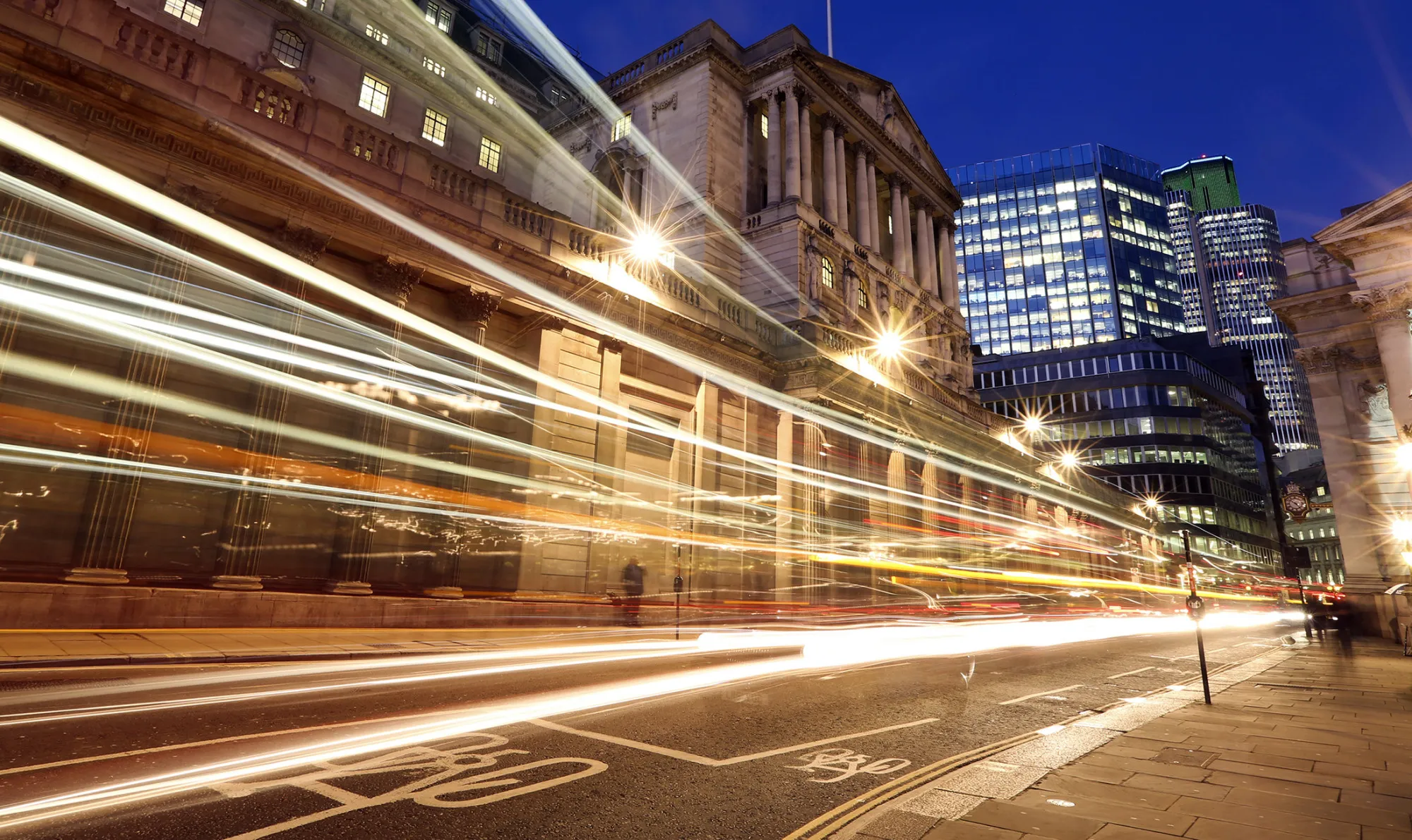 Light trails made by passing vehicles are seen outside the Bank of England (BOE), in London, U.K., on Wednesday, Jan. 9, 2013. Bank of England policy makers will probably refrain from adding further stimulus to the U.K. economy today as their new credit-boosting program shows early signs of success.
