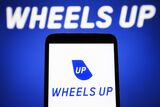 In this photo illustration, Wheels Up logo is seen on a