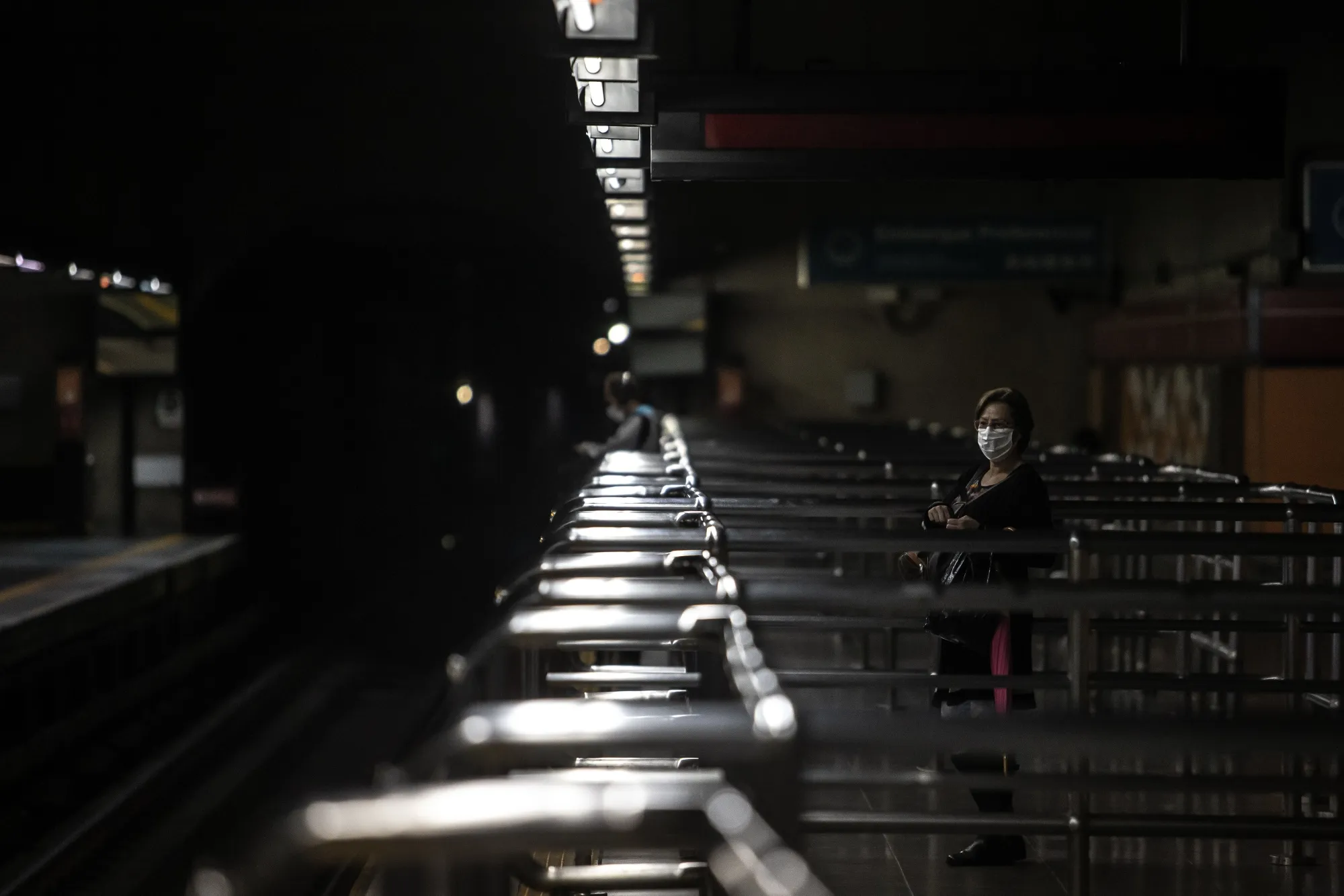 A commuter wearing a protective mask waits for a train at the Se subway station in Sao Paulo, Brazil, on&nbsp;May 26.