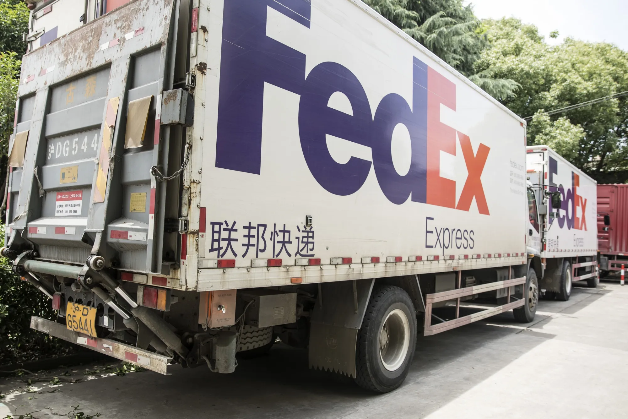 The FedEx Corp. logo is displayed on the side of trucks in Shanghai, China.