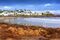 Punta del Este beach, Maldonado, Uruguay, 2014.View of beach at Punta del Este, Maldonado, Uruguay.Image taken outdoors, daylight.Some people appears on the image at the sand on the beach. Also there is a surfer walking on the shore (water), and others surfers are on the water.