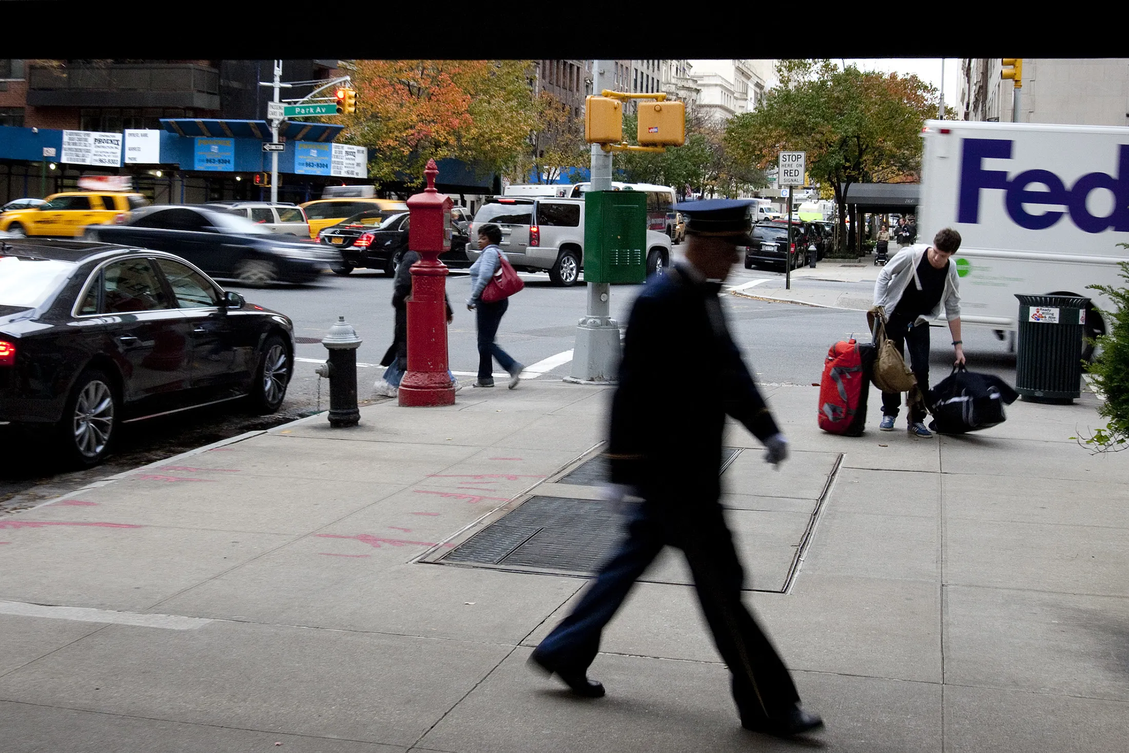 A doorman walks underneath an awning of a residential building in&nbsp;New York.