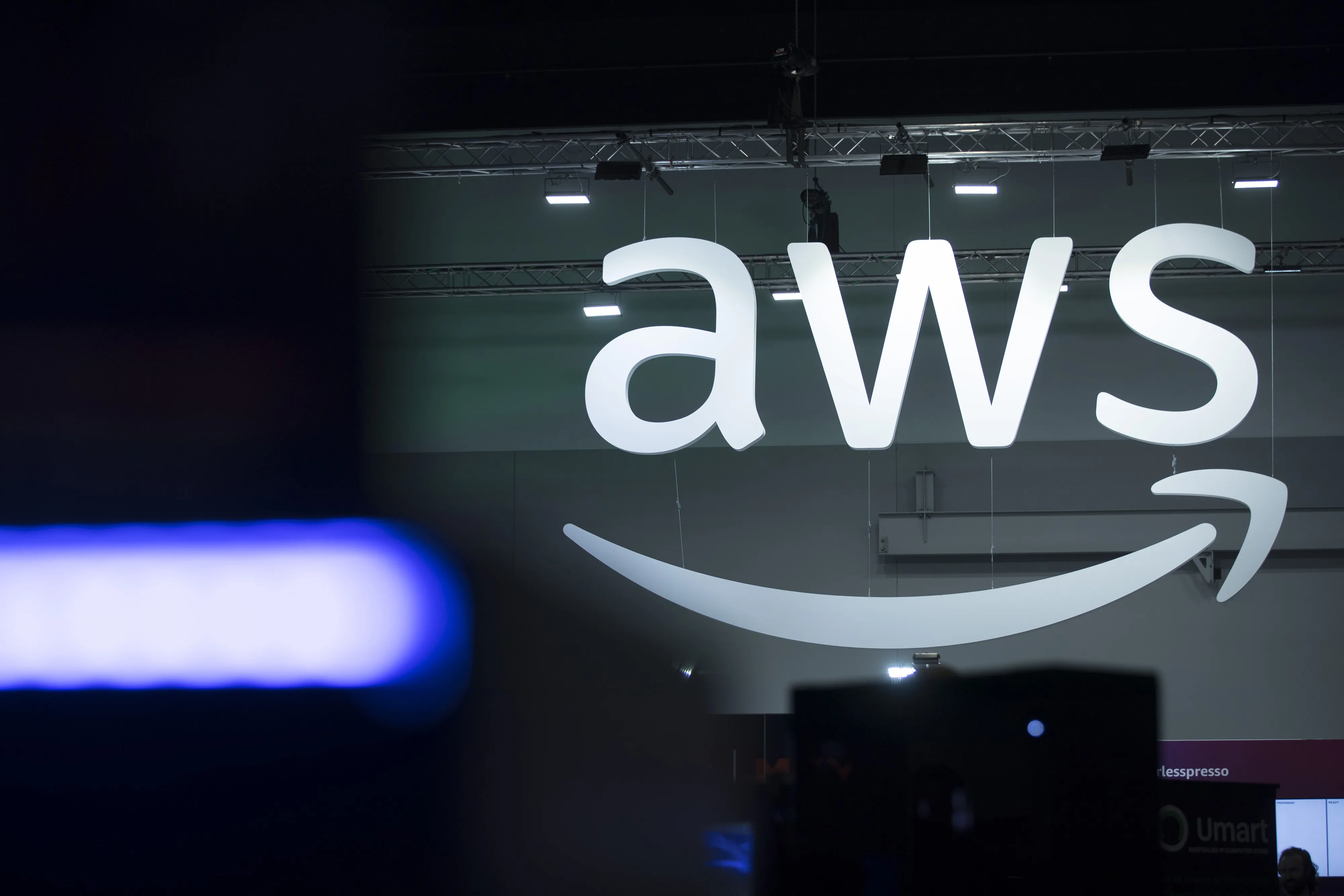 An illuminated Amazon Web Services logo at a Tech &amp; Innovation Expo in Sydney.