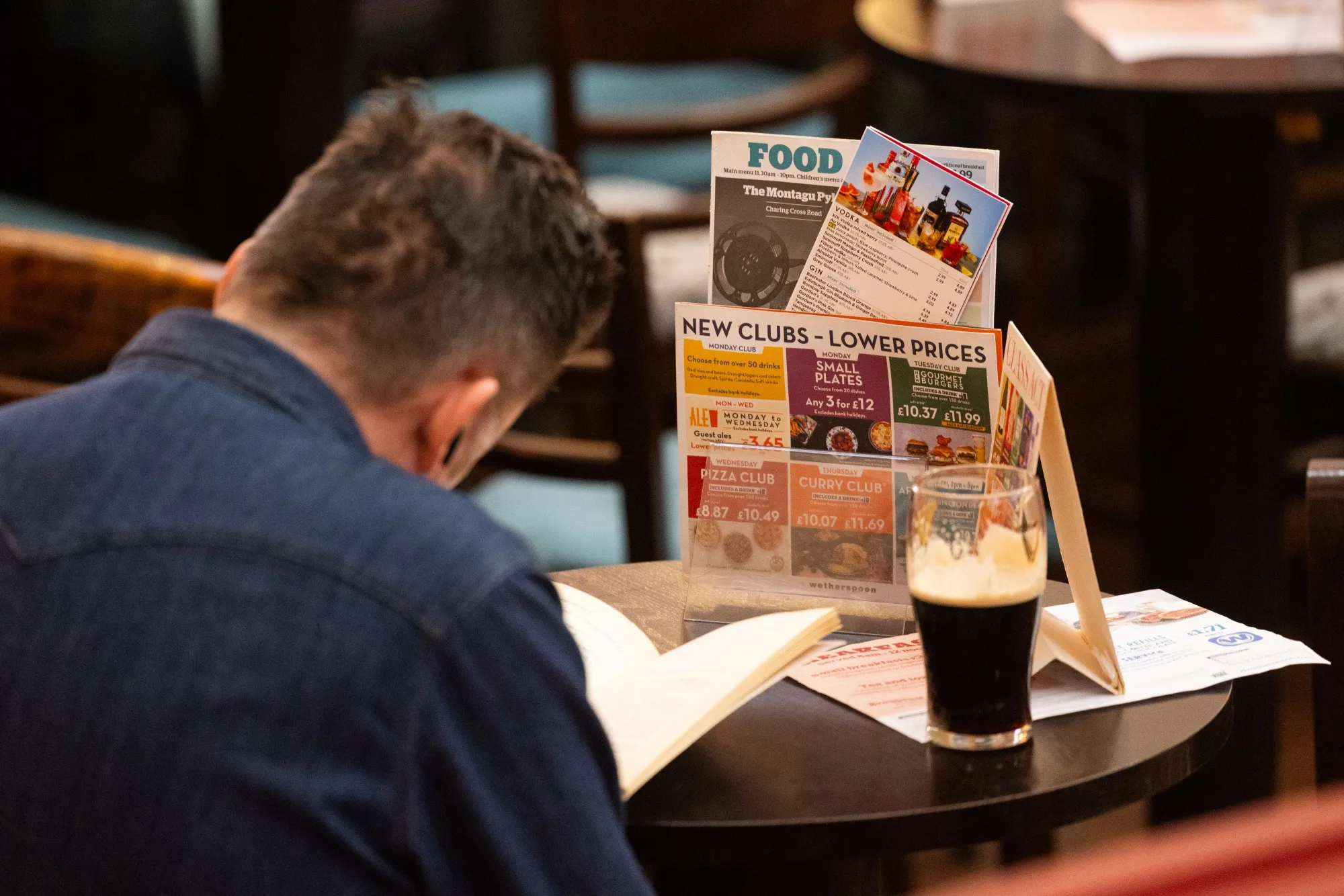A customer at a pub, operated by JD Wetherspoon Plc, in central London.