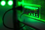 Green light illuminates the case of a mining rig operating inside a shipping container converted into a mobile cryptocurrency mining farm, operated by BitCluster, at Rodniki Industrial Park in Rodniki, Russia, on Tuesday, Feb. 6, 2018.