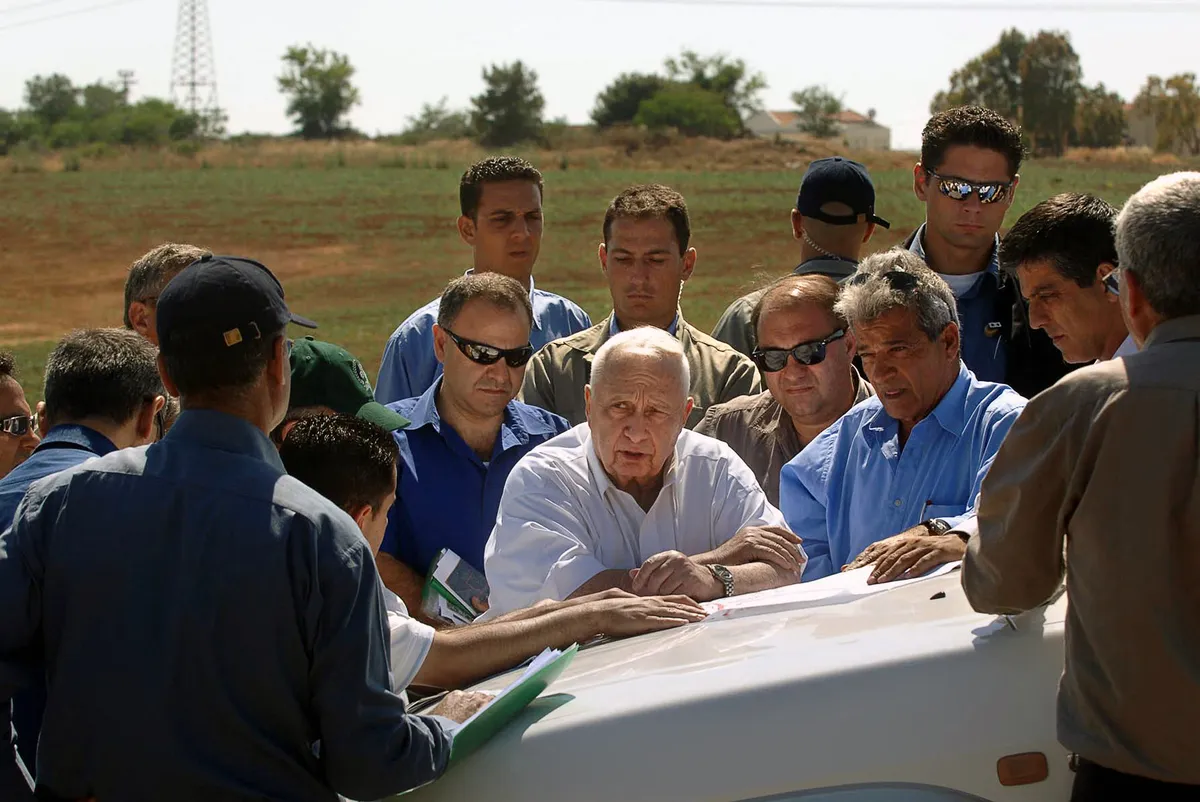 Ariel Sharon in May 2005, on a tour of Israel’s northern Negev region, studies military maps to assess resettlement locations for settlers he intended to remove from the occupied Gaza Strip.